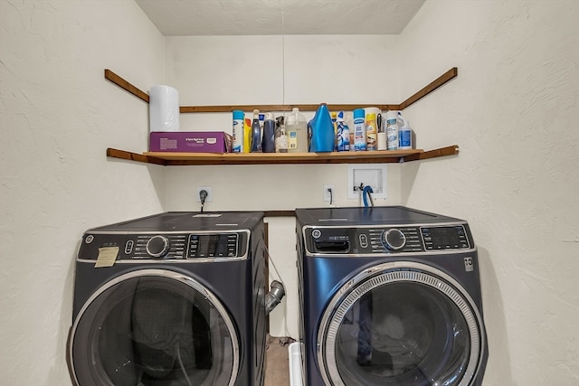 laundry area featuring a textured ceiling and washing machine and dryer