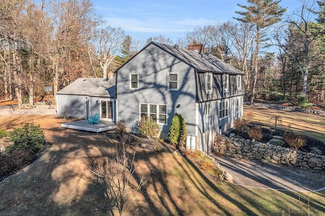 back of house featuring a wooden deck