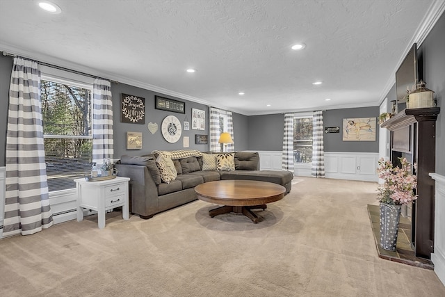 living room with light carpet, a textured ceiling, and ornamental molding