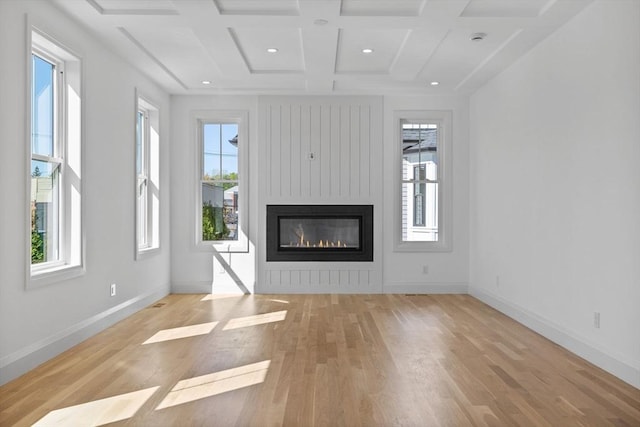 unfurnished living room with light wood-style floors, baseboards, coffered ceiling, a large fireplace, and recessed lighting