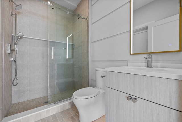 full bath featuring toilet, a shower stall, and vanity