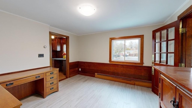 home office with crown molding, a baseboard radiator, and light wood-type flooring