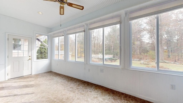 unfurnished sunroom featuring a wealth of natural light and ceiling fan