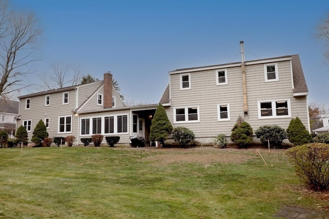 back of property featuring a lawn