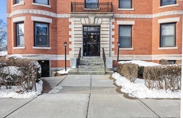 view of snow covered property entrance