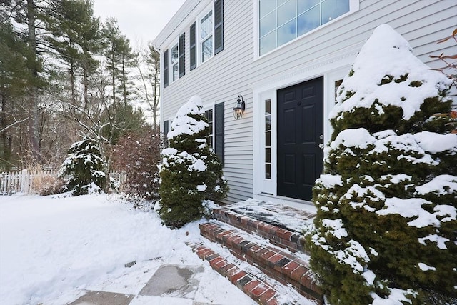 view of snow covered property entrance