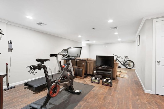 exercise room featuring ornamental molding, wood finished floors, baseboards, and recessed lighting