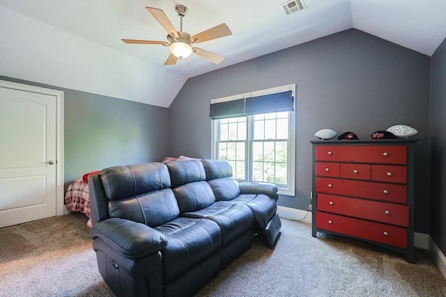 living area featuring lofted ceiling, ceiling fan, carpet, and baseboards