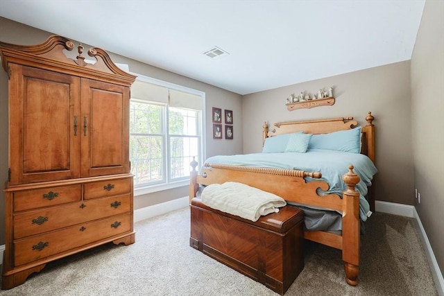 bedroom with baseboards and light colored carpet