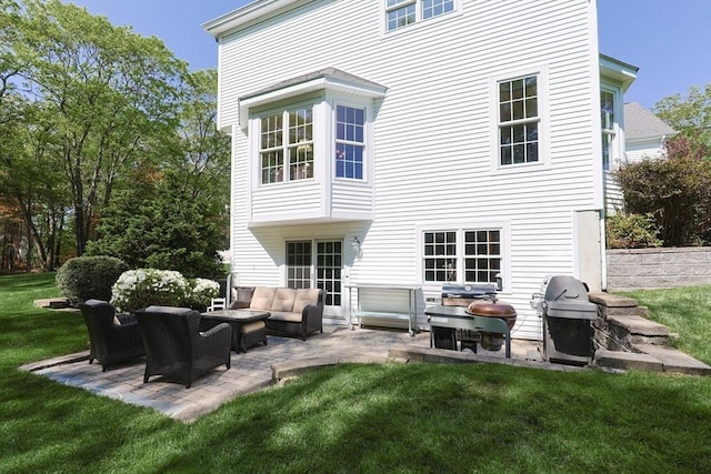 back of house featuring an outdoor hangout area, a patio, and a lawn