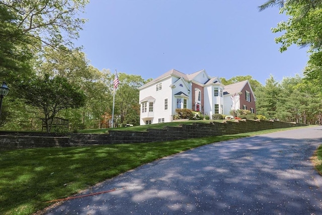 view of home's exterior with a lawn