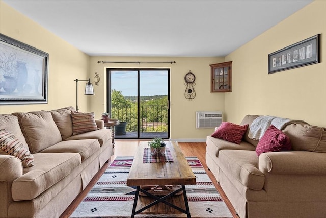 1321 Worcester Rd Unit 605, Framingham, MA 01701 - living area featuring a wall mounted AC and light wood-type flooring