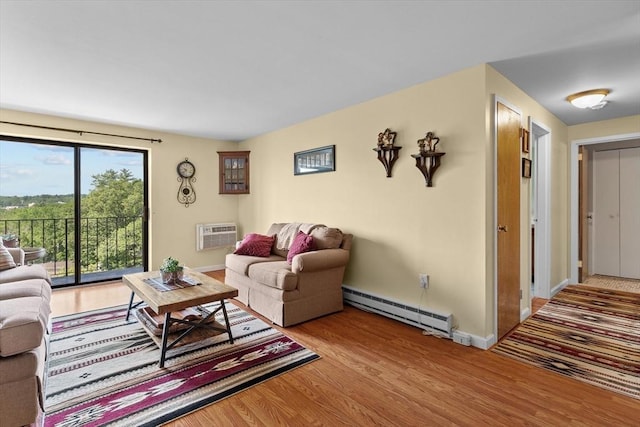 1321 Worcester Rd Unit 605, Framingham, MA 01701 - living area featuring a baseboard radiator, a wall mounted air conditioner, and wood finished floors
