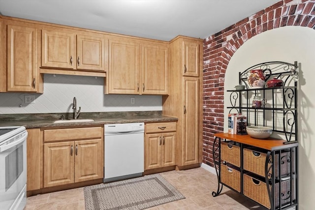 1321 Worcester Rd Unit 605, Framingham, MA 01701 - kitchen featuring white appliances, dark countertops, tasteful backsplash, light brown cabinets, and brick wall