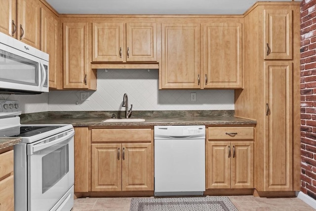 1321 Worcester Rd Unit 605, Framingham, MA 01701 - kitchen featuring white appliances, dark countertops, brick wall, and tasteful backsplash