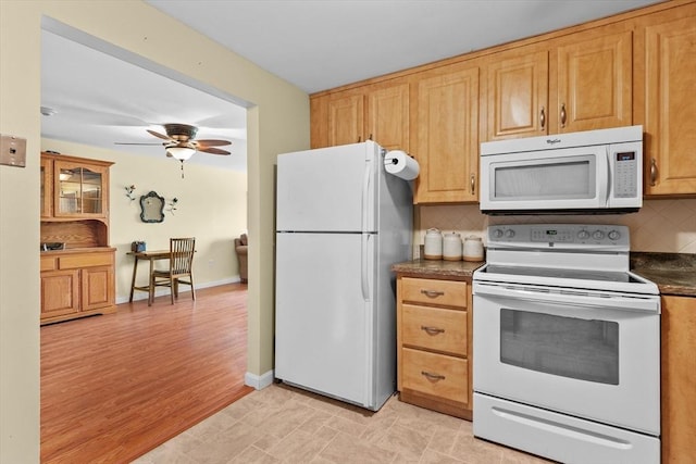 1321 Worcester Rd Unit 605, Framingham, MA 01701 - kitchen with white appliances, dark countertops, backsplash, and a ceiling fan