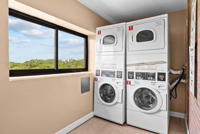 1321 Worcester Rd Unit 605, Framingham, MA 01701 - communal laundry room featuring stacked washer and clothes dryer, washing machine and clothes dryer, and light tile patterned floors