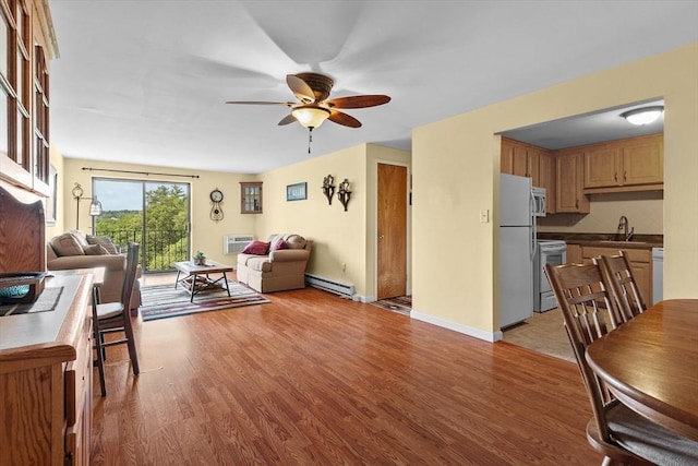 1321 Worcester Rd Unit 605, Framingham, MA 01701 - living room featuring ceiling fan, light wood-style floors, a baseboard heating unit, and an AC wall unit