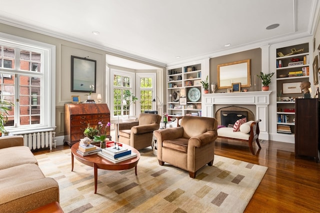 living room with crown molding, french doors, radiator, built in features, and wood-type flooring