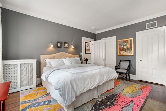 bedroom featuring dark hardwood / wood-style flooring and crown molding