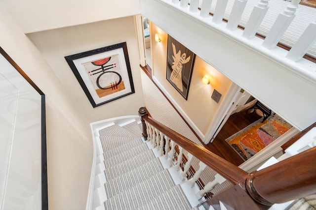 stairway featuring a high ceiling and carpet