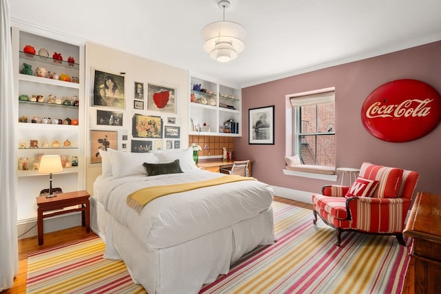 bedroom featuring hardwood / wood-style flooring and ornamental molding