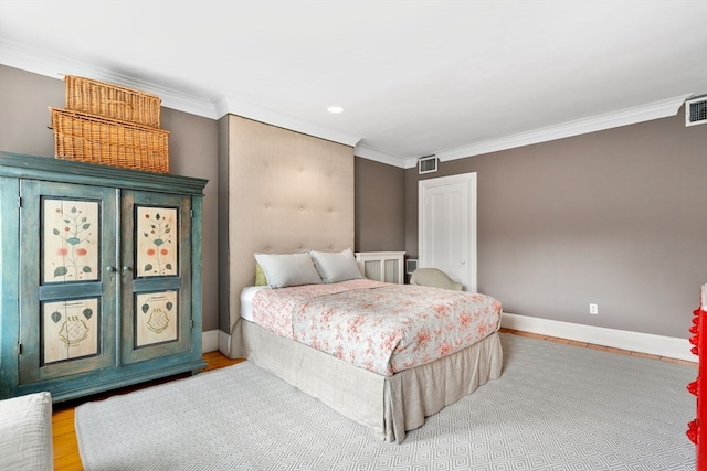 bedroom featuring ornamental molding and wood-type flooring