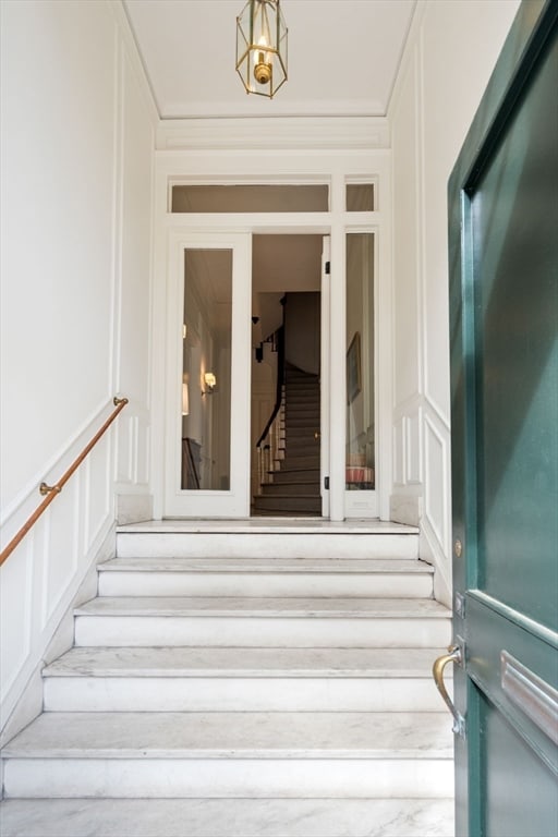 stairway featuring crown molding