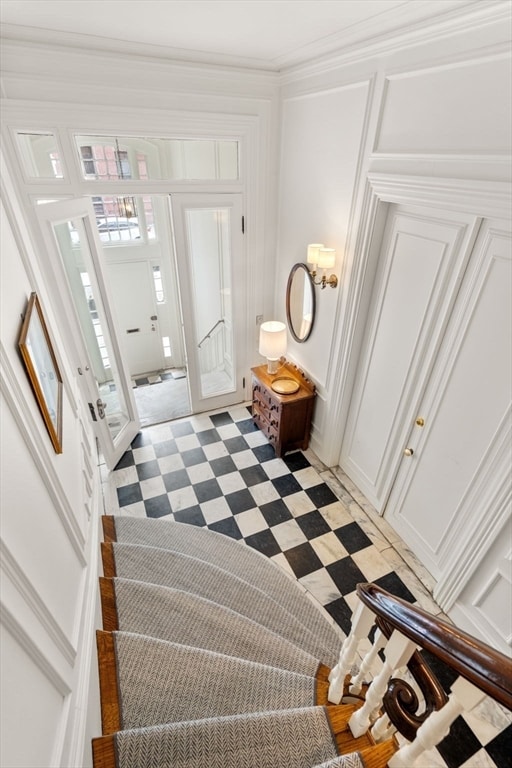 tiled entrance foyer with ornamental molding