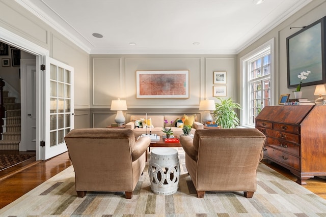 living room with ornamental molding and hardwood / wood-style flooring