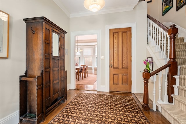 foyer with crown molding and dark hardwood / wood-style floors