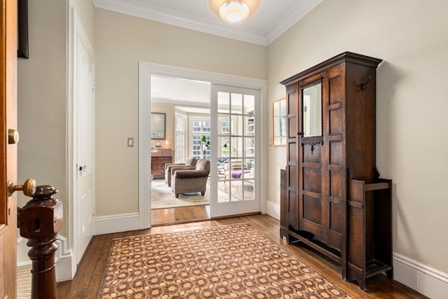 foyer entrance featuring hardwood / wood-style flooring and ornamental molding