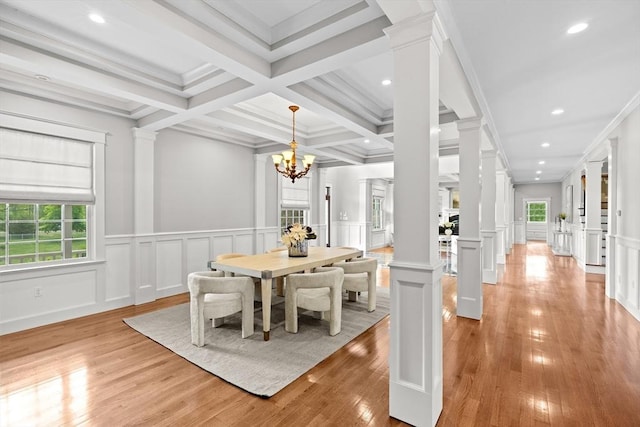 33 Moniz Dr, Westport, MA 02790 - dining room featuring decorative columns, light wood-style floors, a decorative wall, beam ceiling, and a chandelier
