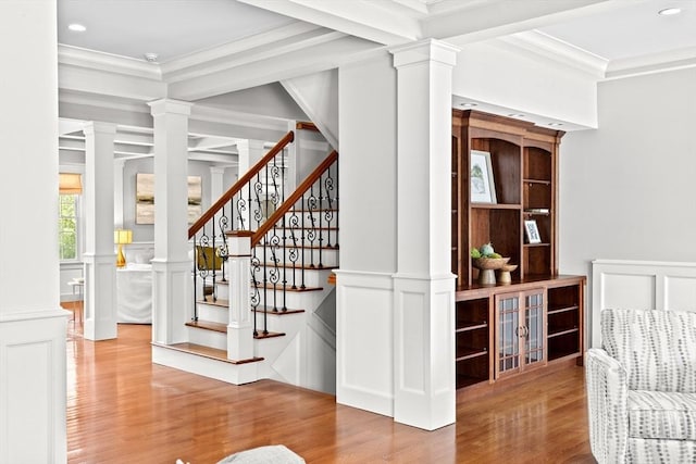 33 Moniz Dr, Westport, MA 02790 - stairs featuring a decorative wall, wood finished floors, decorative columns, crown molding, and wainscoting