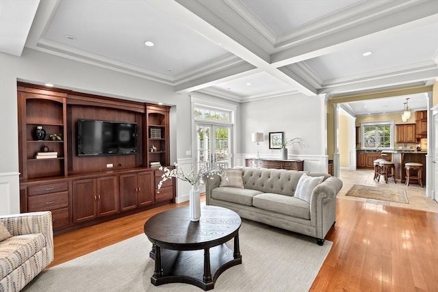 33 Moniz Dr, Westport, MA 02790 - living area featuring light wood finished floors, beamed ceiling, crown molding, a wainscoted wall, and a decorative wall