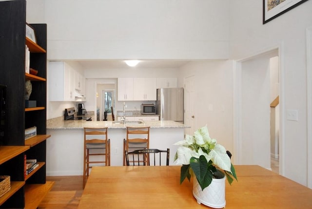 dining room featuring sink and light wood-type flooring