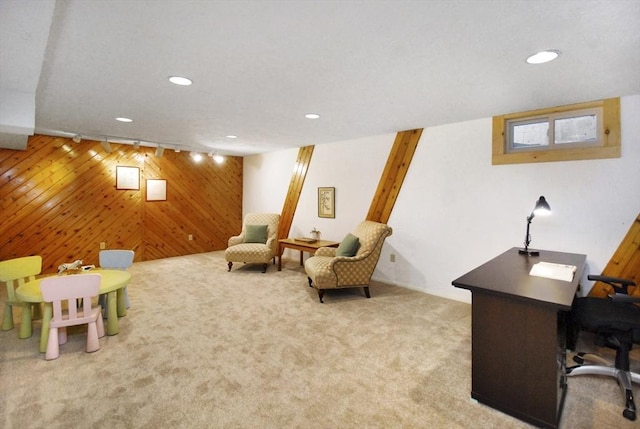 carpeted office featuring wood walls