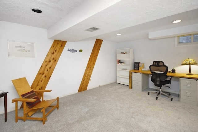 carpeted office featuring a textured ceiling