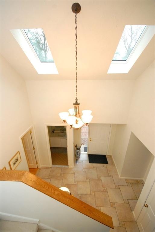 interior space featuring a skylight and a notable chandelier