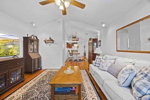 living room featuring light wood-type flooring, ceiling fan, and lofted ceiling