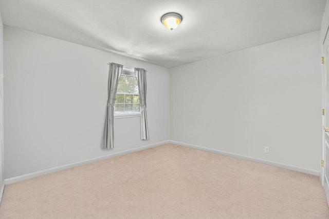 unfurnished room featuring light colored carpet