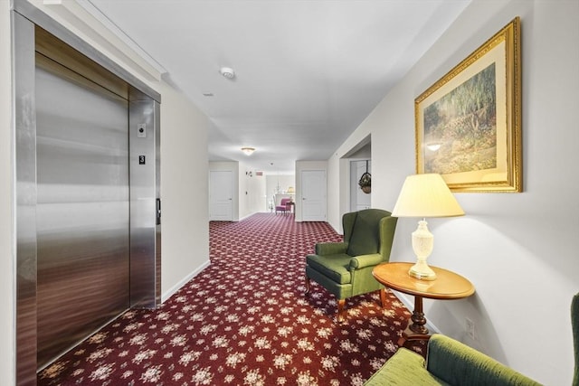 corridor featuring elevator and carpet flooring