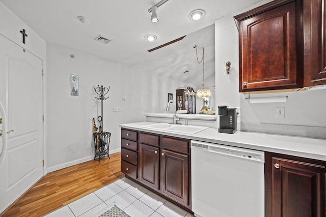 kitchen featuring sink, pendant lighting, light tile patterned floors, and dishwasher