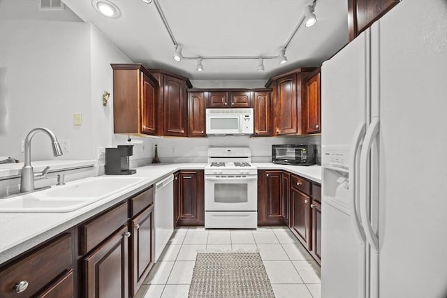 kitchen with sink, white appliances, and light tile patterned flooring