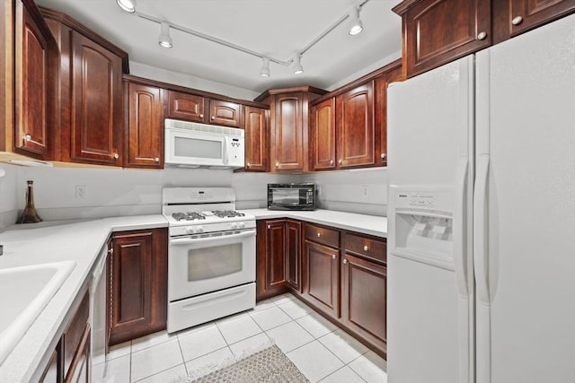 kitchen featuring sink, white appliances, and light tile patterned floors