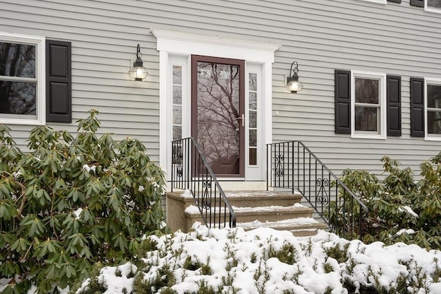 view of snow covered property entrance