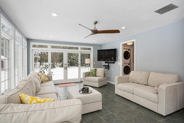 living room with ceiling fan, french doors, and stacked washer / dryer