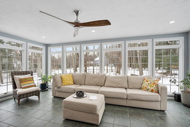 sunroom featuring ceiling fan