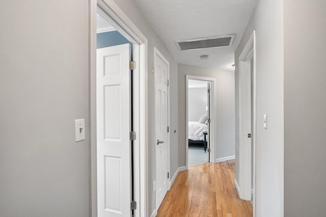 corridor with light hardwood / wood-style flooring