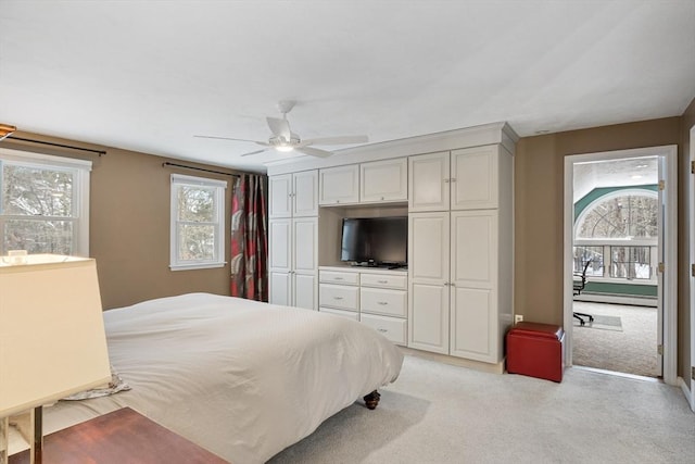 bedroom featuring ceiling fan, light colored carpet, and baseboard heating